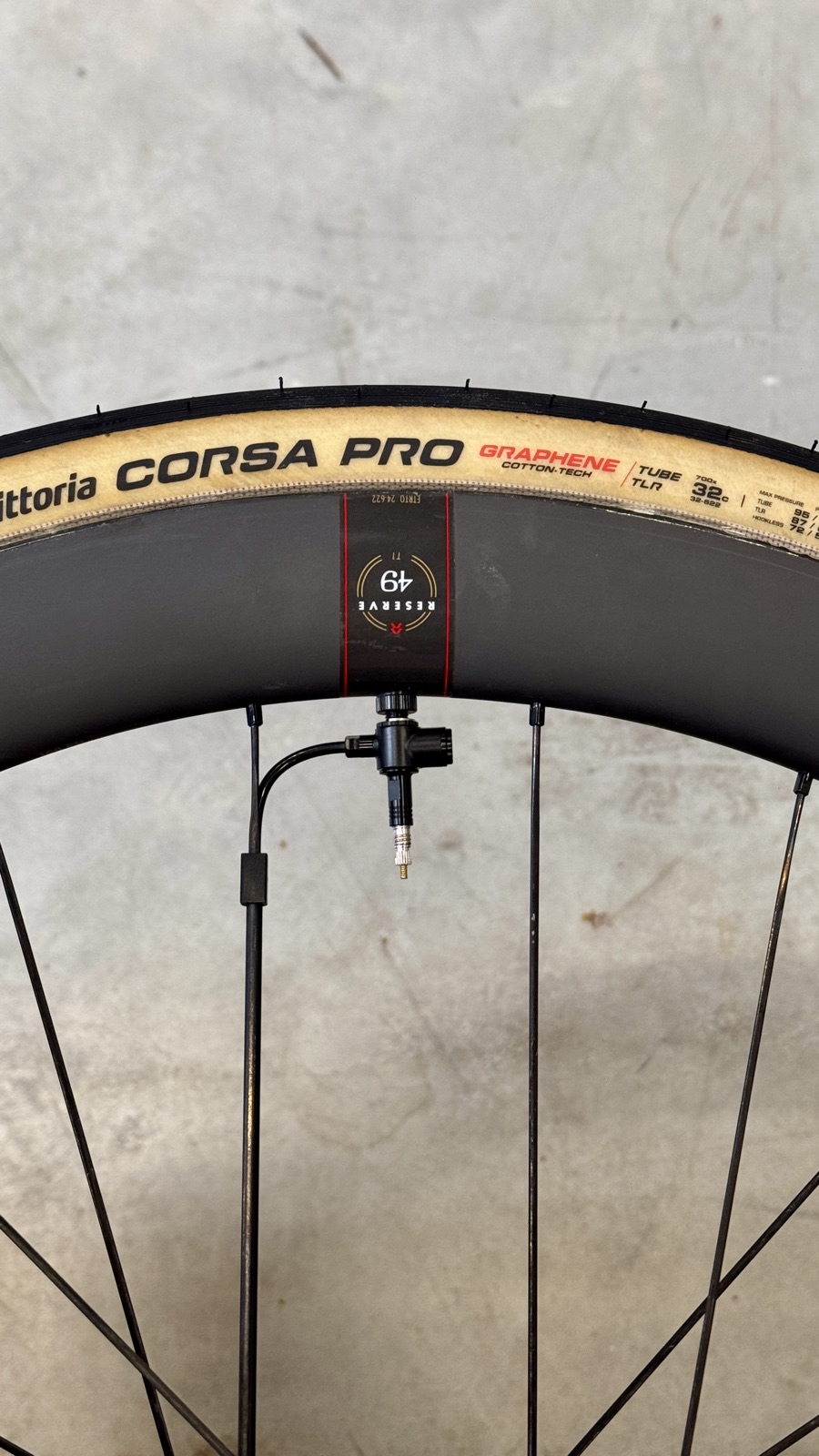 Close-up of a GRAVAA inflation valve mounted in a Reserve carbon wheel
