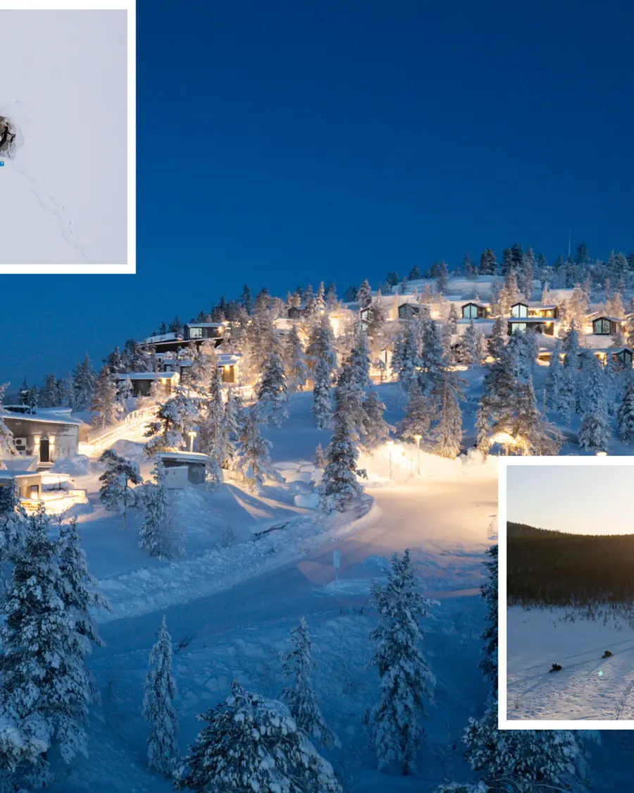 The lodge village on the hillside, windows glowing through snow-laden pines