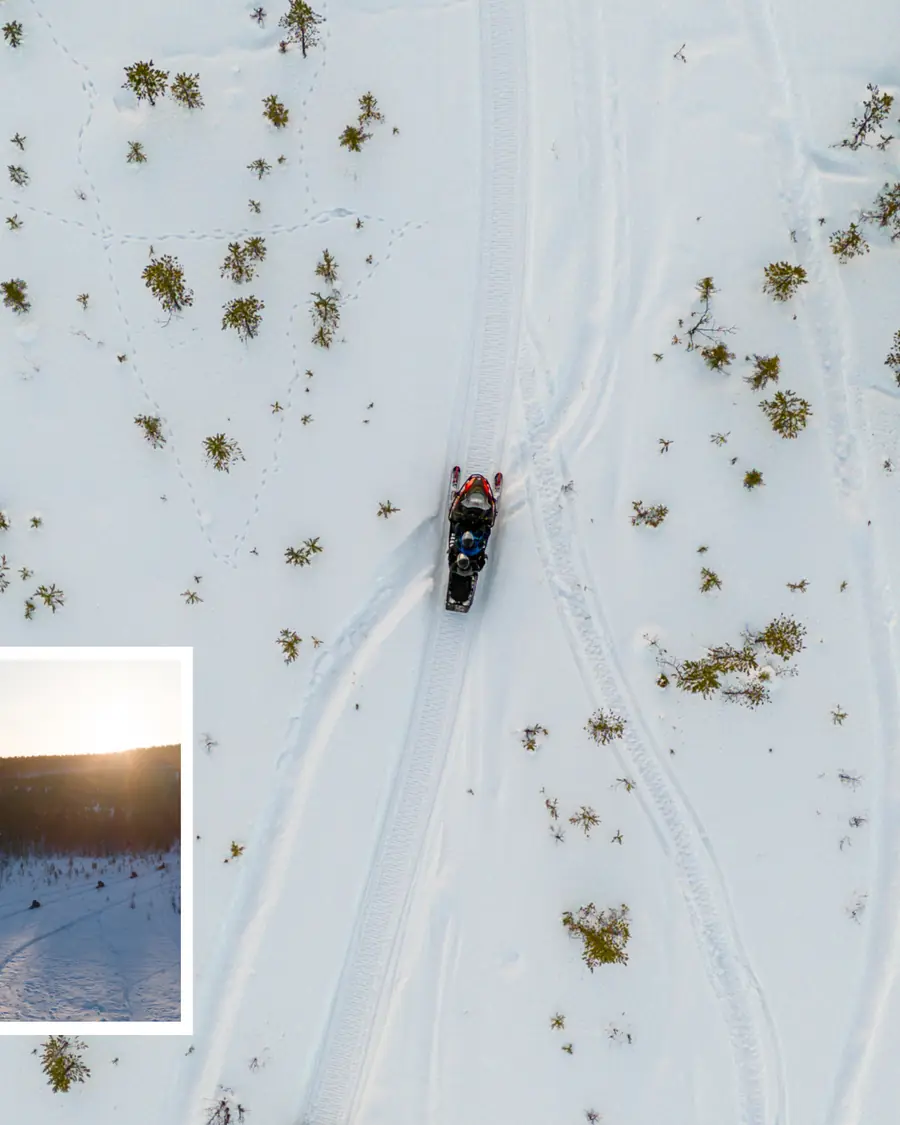 A snowmobile and sled photographed from directly overhead on a groomed track